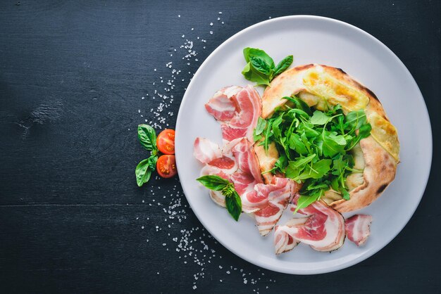 Salad with meat and vegetables Italian cuisine On a wooden background Top view Free space for your text