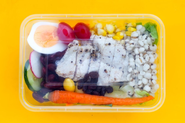 Salad with meat and vegetables in plastic package box