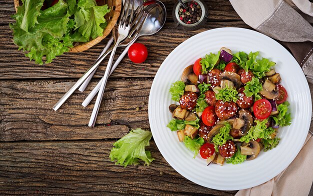 Salad with meatballs, eggplant, mushrooms and tomatoes in Asian style. Healthy food. Diet meal. Top view. Flat lay.