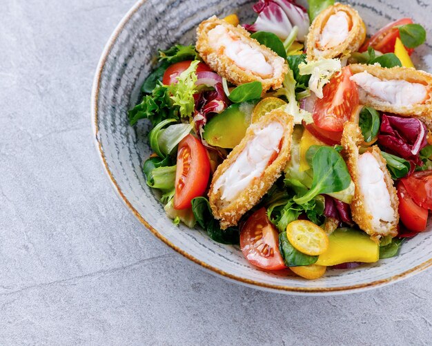 salad with panko shrimp avocado and mango on a gray background for the restaurant menu