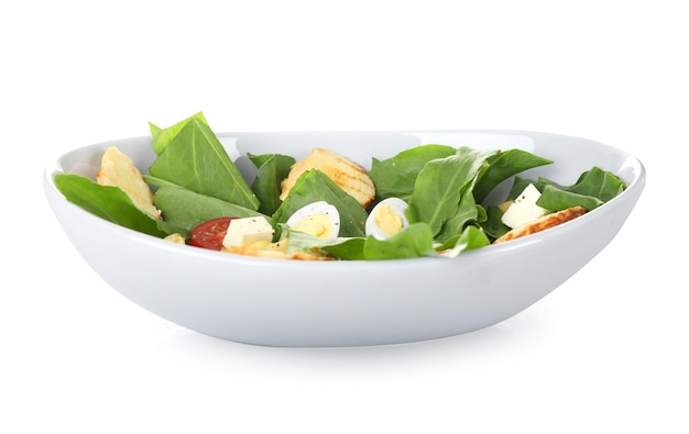 Salad with quail eggs and spinach in bowl isolated on white