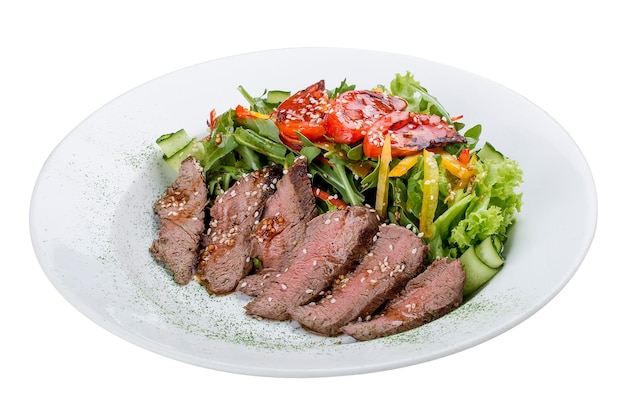 Salad with roast beef and sundried tomatoes on white background