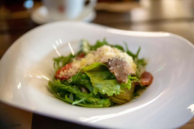 Salad with roast beef in a white plate Traditional cuisine