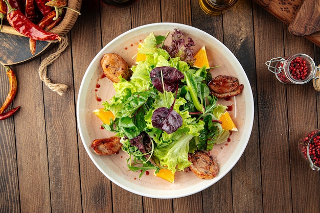 Salad with roasted duck greens and oranges mix