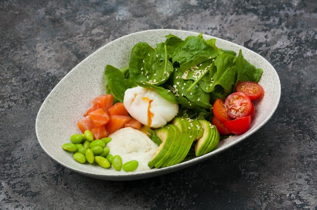 Salad with salmon avocado beans and poached egg