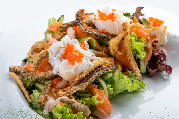 Salad with salmon belly shrimp and poached egg On white background