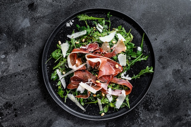 Salad with Serrano jamon, ham, rucola and Parmesan cheese