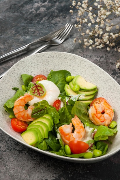 Salad with shrimp avocado beans and poached egg