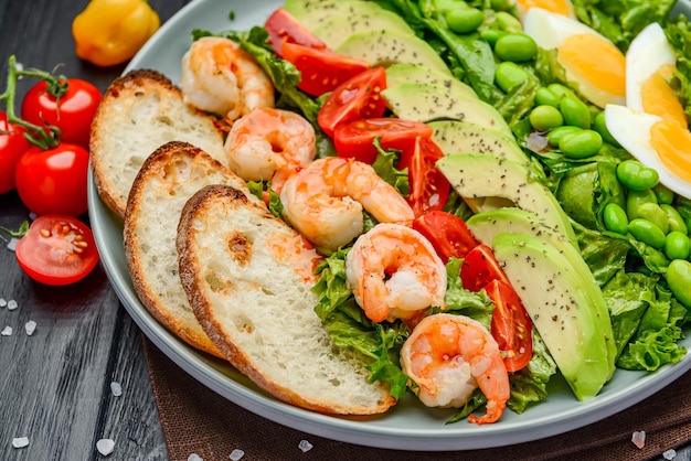 Salad with shrimp avocado green beans croutons and egg Serving in a restaurant Photo for the restaurant menu