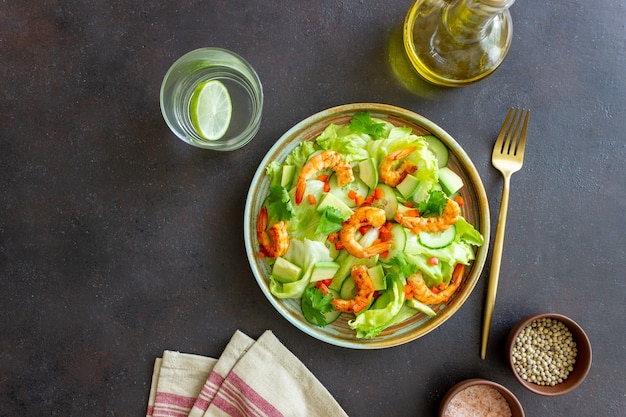 Salad with shrimp, cucumbers and avocado. Healthy eating. Vegetarian food.