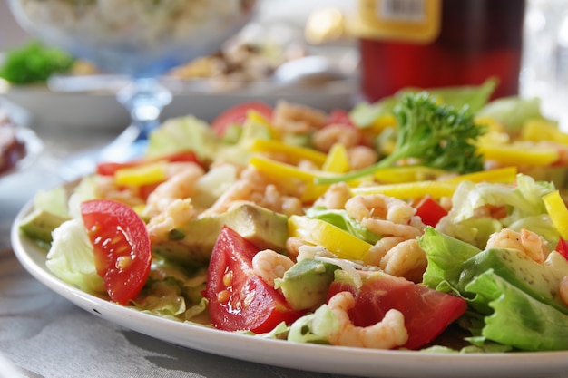 Salad with shrimp on a festive table. Closeup