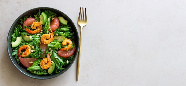 Salad with shrimp grapefruit avocado and nuts Healthy eating Diet