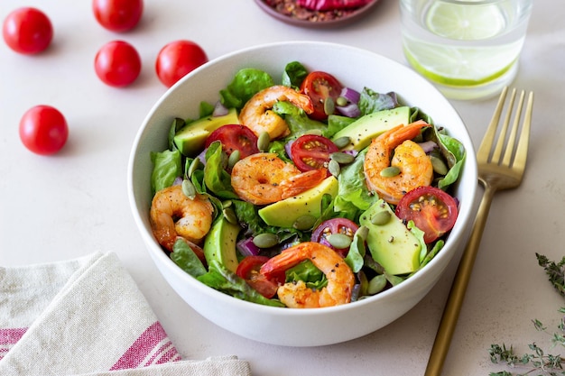 Salad with shrimps avocado tomatoes onions and seeds Healthy eating Diet