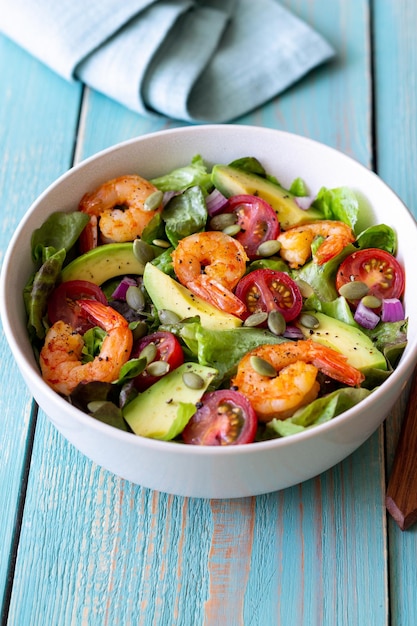 Salad with shrimps avocado tomatoes onions and seeds Healthy eating Diet