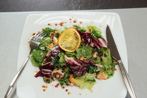 Salad with shrimps and greens on a plate on the table