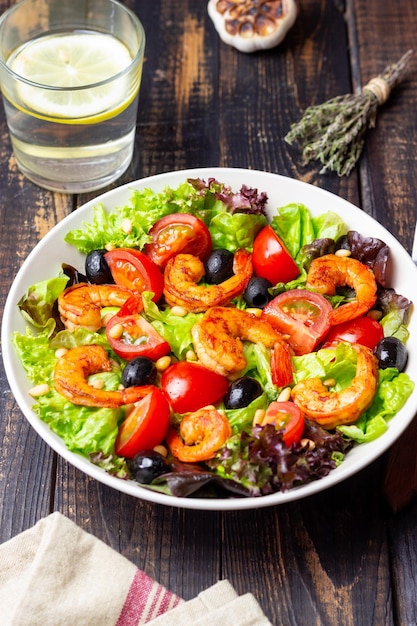 Salad with shrimps tomatoes olives and nuts Healthy eating