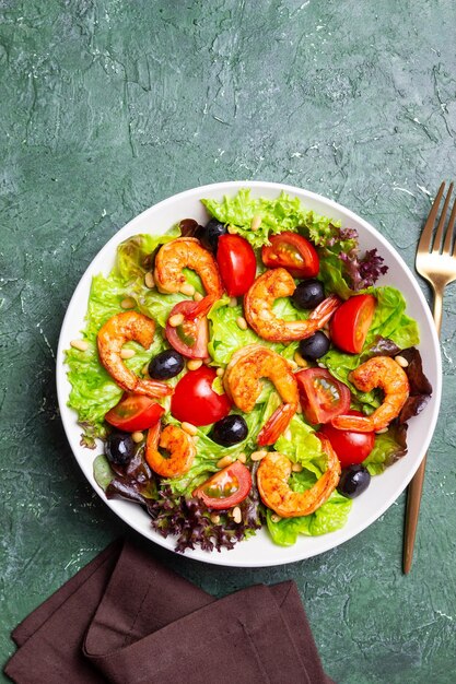 Salad with shrimps tomatoes olives and nuts Healthy eating