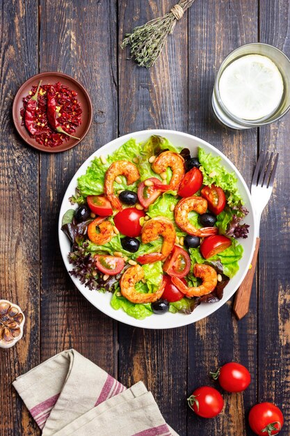 Salad with shrimps tomatoes olives and nuts Healthy eating