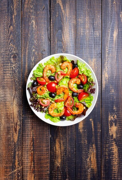 Salad with shrimps tomatoes olives and nuts Healthy eating