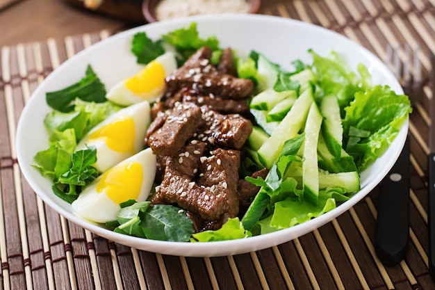 Salad with spicy beef, cucumber and eggs in the asian style.