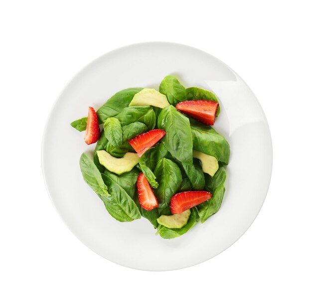 Salad with spinach leaves and strawberry on white background