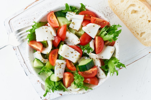 Salad with squid, cucumbers, tomatoes, lettuce. LCHF, FODMAP, paleo diet. Healthy Mediterranean food