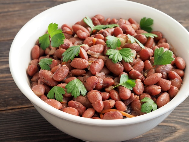 Salad with stewed beans, garlic and green parsley.