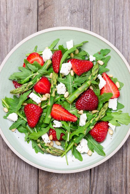 Salad with strawberries asparagus arugula white cheese and nuts Healthy eating Vegetarian food