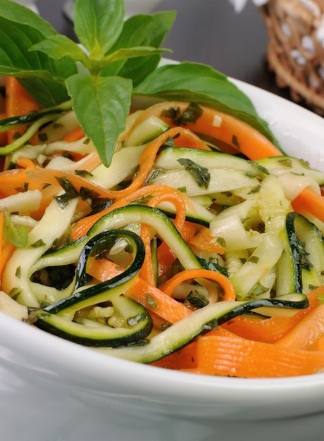 Salad with strips of carrot and zucchini pesto sauce