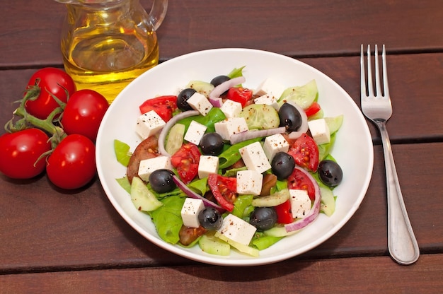 A salad with tomatoes, cheese, and tomatoes on a table.