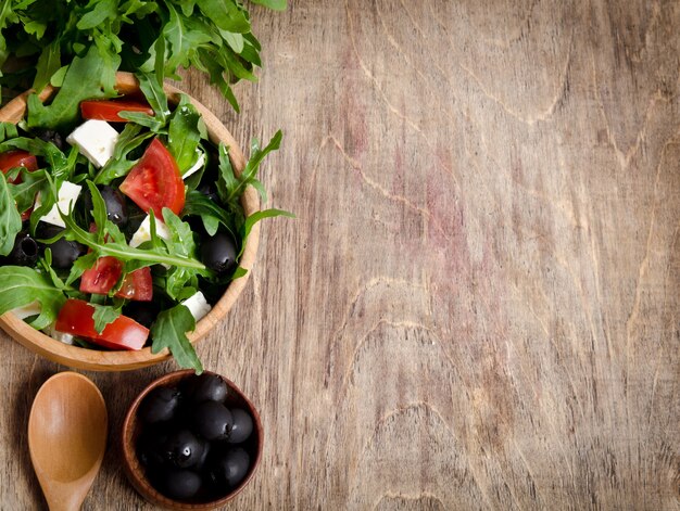 Salad with tomatoes and olives in a bowl