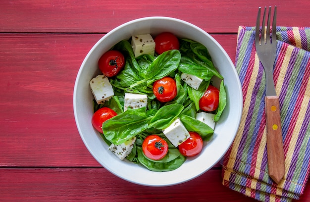 Salad with tomatoes, spinach and cheese.