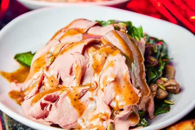 Salad with veal spinach vegetables and pumpkin seeds