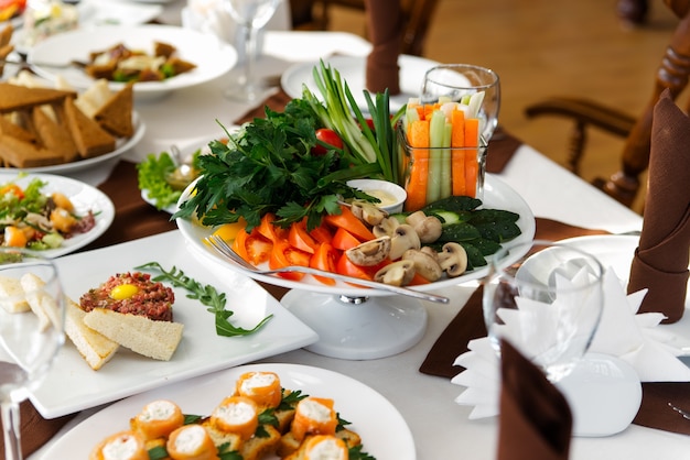 Salad with vegetables and greens on wooden table