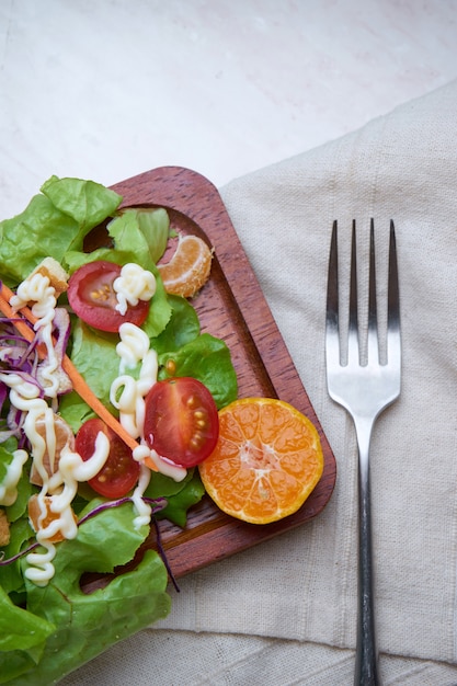 Salad in wooden plate