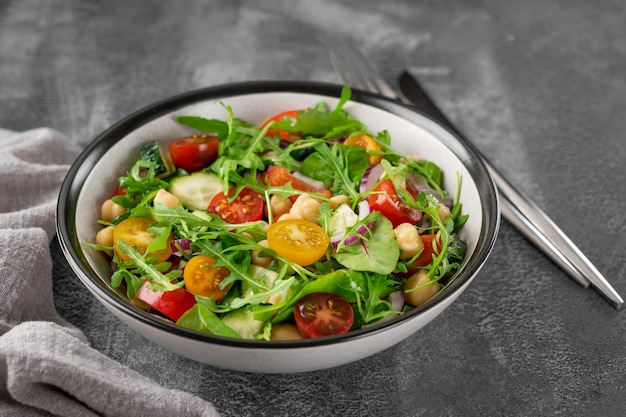 Salade met kikkererwten, groene bladeren en verse groenten Gezonde voeding Bovenaanzicht kopieerruimte