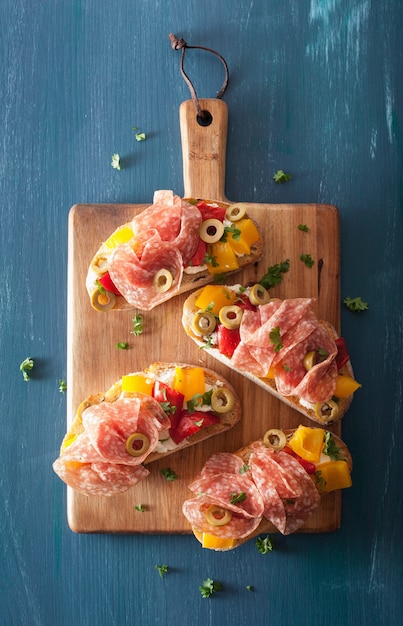 Salami bruschetta with roasted peppers goat cheese olives