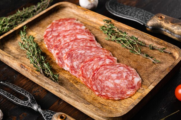 Salami Milano sliced sausage set, on old dark  wooden table background