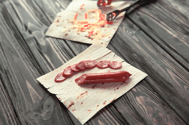 Salami for preparation of shawarmaphoto on a wooden background