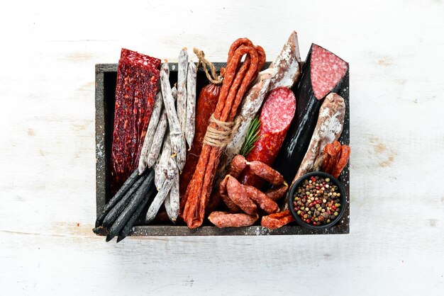 Salami sausages spices and meat products in a wooden box top
view free space for your text