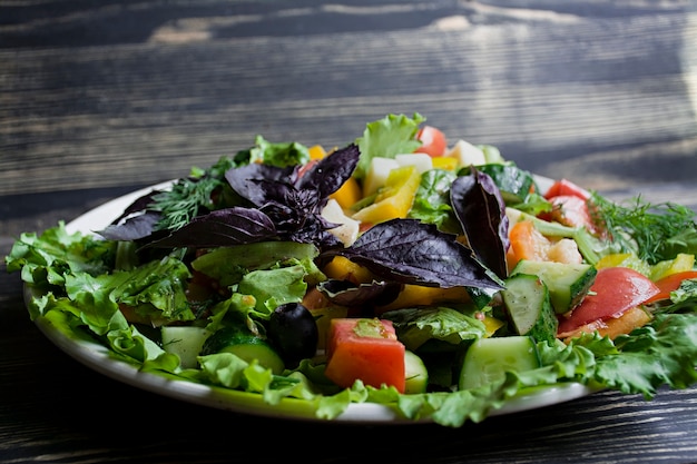 Salami, sliced ham and cheese salad and vegetables. 