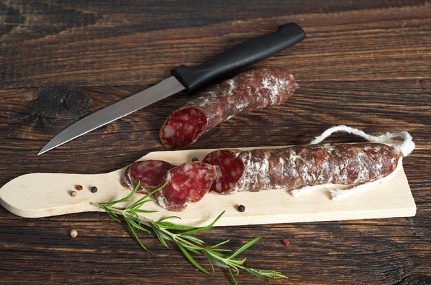 Salami sliced with pepper and rosemary