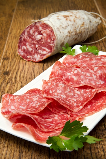 Salame affettato su fondo in legno