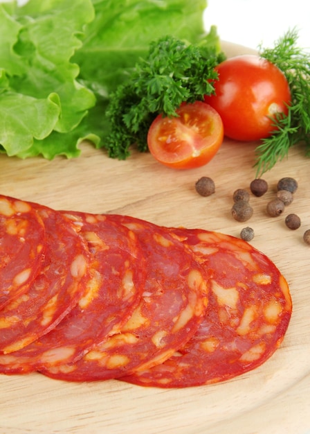 Salami slices on wooden board close up