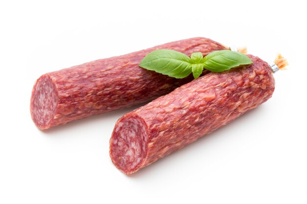 Salami smoked sausage, basil leaves and peppercorns isolated on white background.