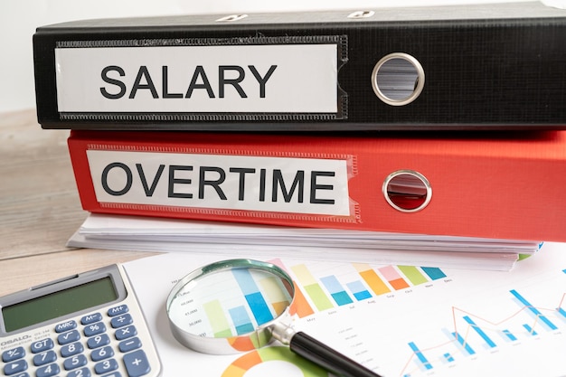 Salary overtime Binder data finance report business with graph analysis in office