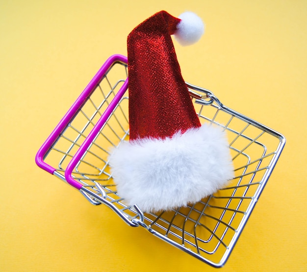 Sale concept. Single Santa Claus red hat in the food basket