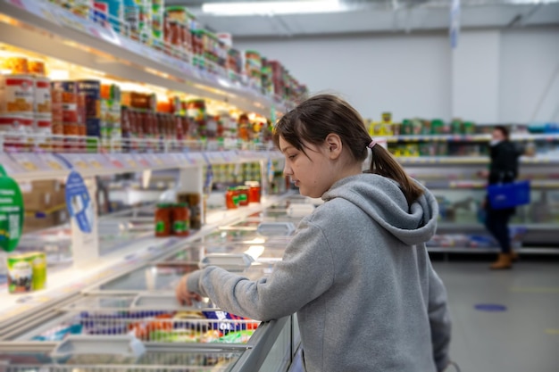 Sale consumerism and people concept happy teen girl in grocery store