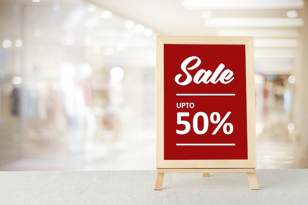 Sale on red board over blur store background