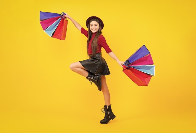 Sale and shopping concept teen girl holding shopping bags\
isolated on studio background run